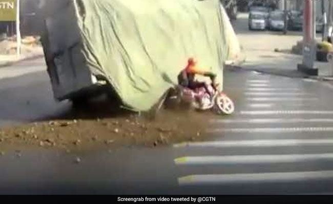 Lorry Carrying Stones Flips Over. Biker's Close Shave Caught On Film