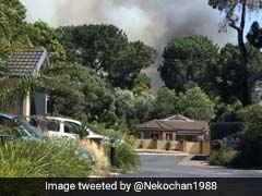 Bushfires Destroy Buildings In Australia As Heatwave Melts Highway