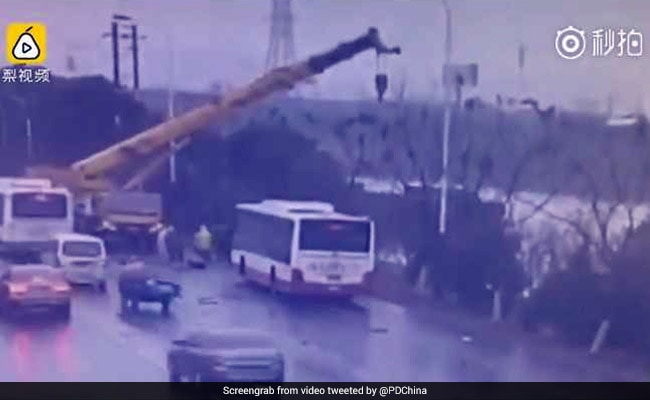 Watch: Crane Driver Rescues Passengers After Bus Falls Into River