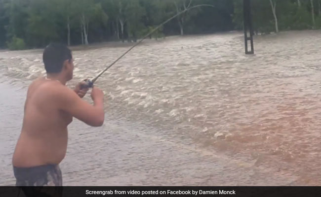 Man Goes Fishing On Flooded Road. Watch The Moment He Landed A Catch