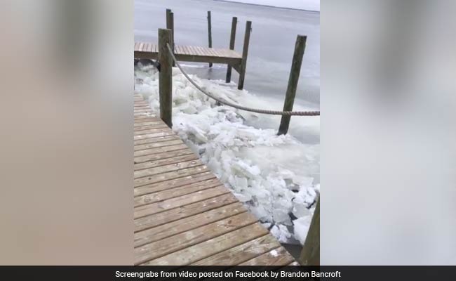 Waves Of Ice Crash Against Dock. Rare Phenomenon Caught On Camera