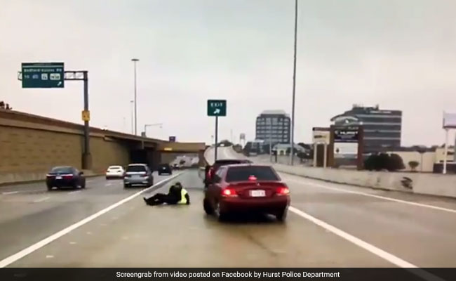 Cop Slips As Oncoming Car Slides On Icy Road. Close Call Caught On Camera