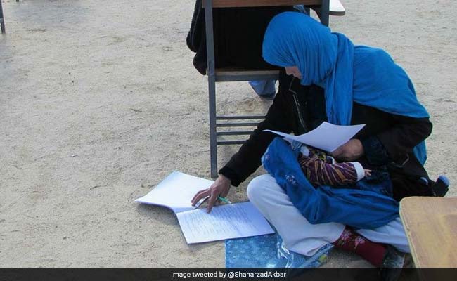 Afghan Woman Takes Exam While Nursing Her Baby. Incredible Pic Is Viral