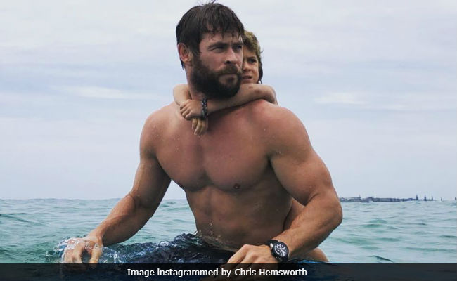 Watch Chris "Thor" Hemsworth Surf With Daughter Like A Boss