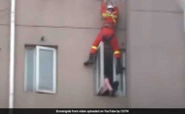 Video: Firefighter Saves Suicidal Woman By Kicking Her Back Into Home