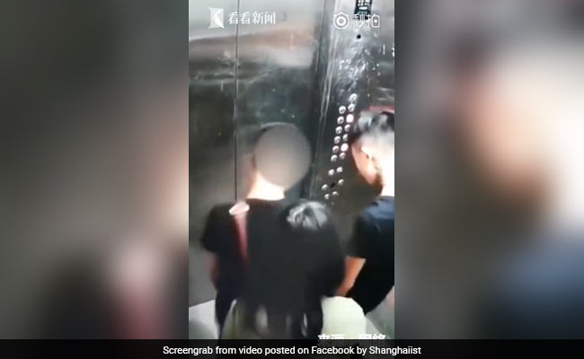 Caught On CCTV: Two Men Pee In Elevator As Woman Tries To Block Camera