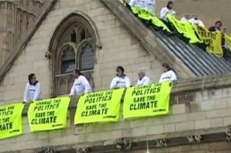 Green protests: Indian atop UK parliament