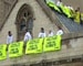 Green protests: Indian atop UK parliament