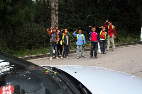 Salute passing cars, students told in Chinese town