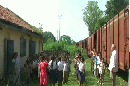 A school that stands between railway tracks