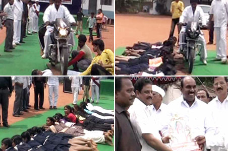 Car, motorcycle drive over the hands of 50 kids