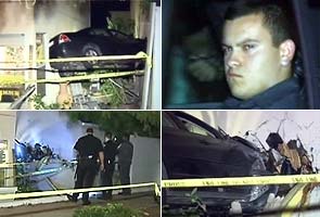 Driver crashes into two homes, leaving car suspended in air