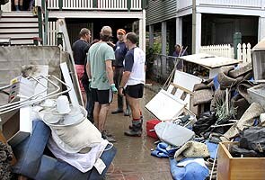 Brisbane digs itself out of stinking sludge Brisbane digs itself out of stinking sludge