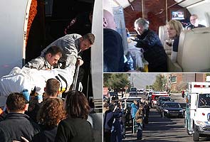 Giffords hears cheers leaving Arizona, smiles