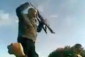 Caught on camera: Gaddafi's son brandishing a machine gun 