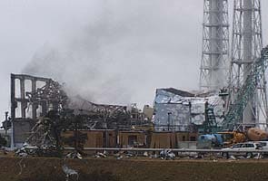 Workers flee Japan nuclear plant as smoke rises