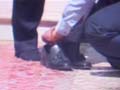 Policeman holds Maharashtra minister's shoes in his hand