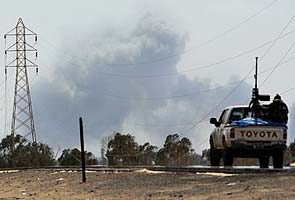 Libyan rebels face military surge on key outpost