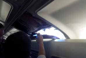 Large hole tears into plane, 118 on board