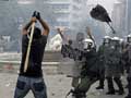 Greece passes steep cuts as riots seize capital