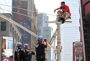 Rapper atop pole stops traffic in Times Square, New York