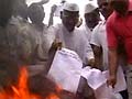 Lokpal Bill tabled, Anna sets a copy on fire