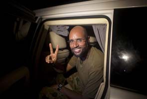 Gaddafi son resurfaces, free and vowing to fight 