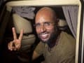 Gaddafi son resurfaces, free and vowing to fight