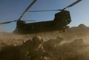 NATO, Afghan forces fight insurgents near chopper crash site