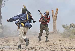 Libyan fighters assault main Gaddafi base in Sirte