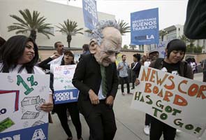 Murdoch takes on shareholders at board meeting; protests outside