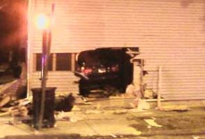 Car slams into house, lands on sleeping man 