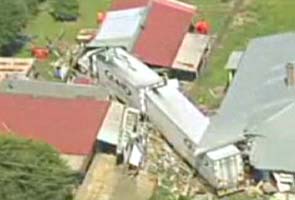 Truck swings off highway, crashes into a house