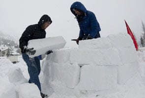 Occupy Davos protesters build igloos