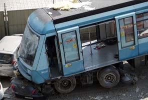 Metro derails in Chile, crashes into building