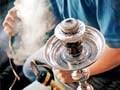 Health minister's son caught puffing hookah despite ban