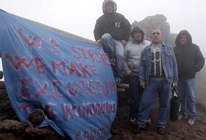 Six men climb into volcano in job loss protest 