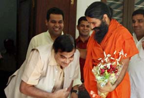 At meeting, BJP President Nitin Gadkari touches Baba Ramdev's feet