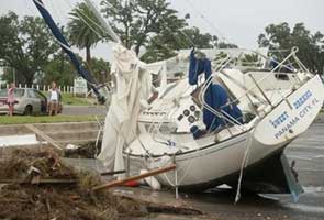 Waning Isaac heads north but eyes turn to stricken dam