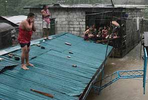 Rains flood Manila, displacing thousands