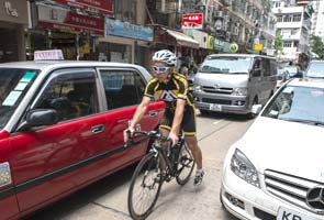 Hong Kong cyclists stuck at government red light