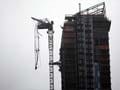Engineers going up to examine dangling New York crane
