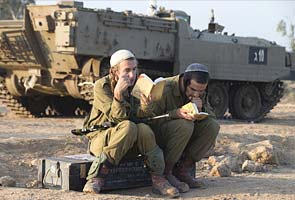 Israel halts threatened Gaza invasion as truce talks build