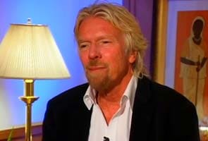 Why billionaire Richard Branson is wearing a stewardess' skirt