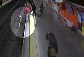 Spain video shows police officer saving woman from tracks