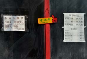 Beijing restaurant removes 'racist' sign after fury