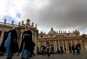Living ex-pope an invisible presence at conclave