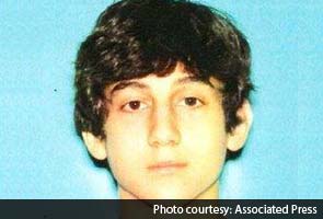 One bombing suspect is dead; search continues for the second