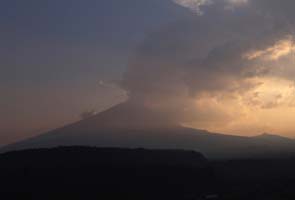 Mexico sets shelters as volcano shakes, spews ash