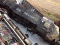 US highway buckles after rail cars hit overpass